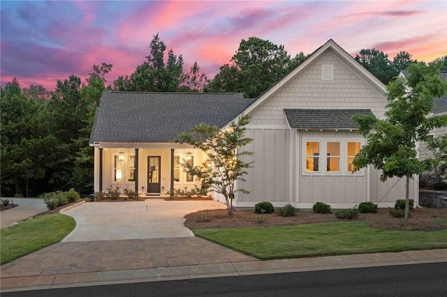 view of front facade featuring a lawn and covered porch