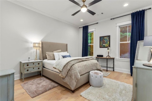bedroom with baseboard heating, ceiling fan, light hardwood / wood-style floors, and ornamental molding