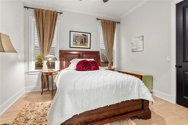 bedroom with ceiling fan, crown molding, and light hardwood / wood-style flooring