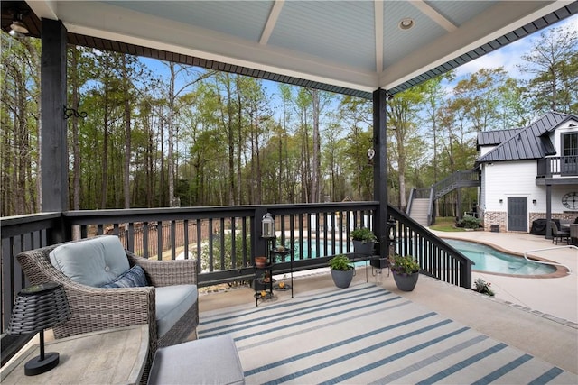 deck featuring a patio, stairs, and an outdoor pool