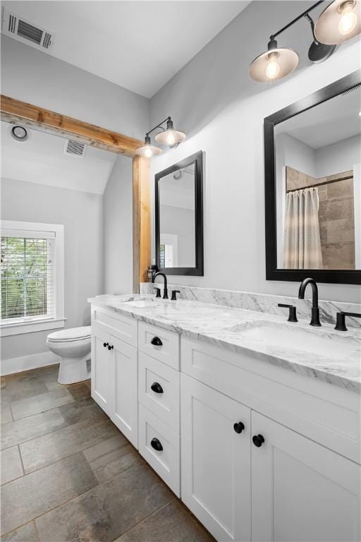 full bath with a sink, visible vents, and toilet