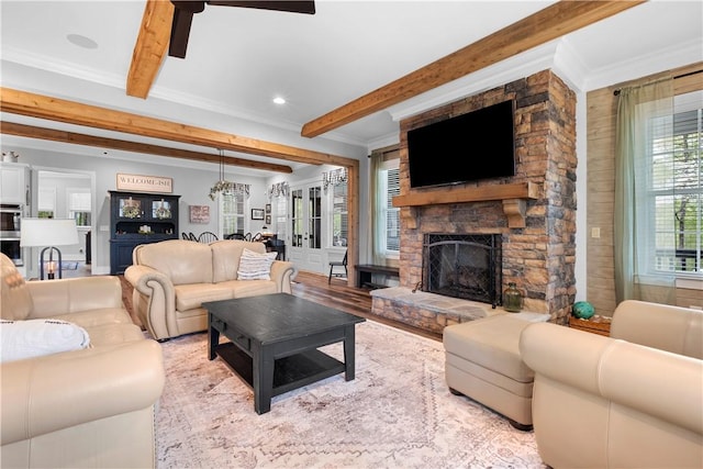 living area featuring a stone fireplace, wooden walls, crown molding, and beam ceiling
