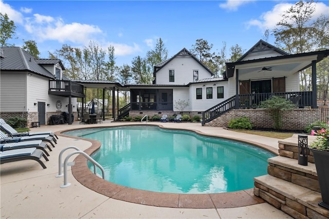 view of pool with stairs, a fenced in pool, a sunroom, a patio, and ceiling fan