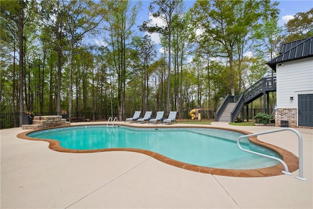 view of swimming pool with fence, stairs, a patio area, and a fenced in pool