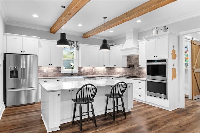 kitchen featuring dark wood-style flooring, custom exhaust hood, stainless steel appliances, a kitchen island, and a sink