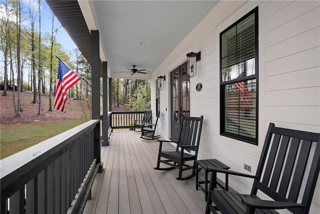 wooden terrace with ceiling fan and a porch