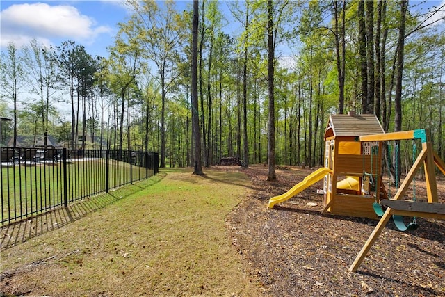 community playground featuring fence and a yard