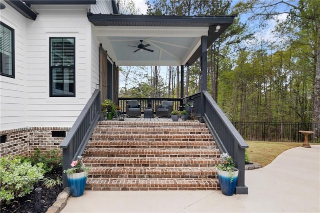 deck featuring a ceiling fan, a porch, stairway, and fence