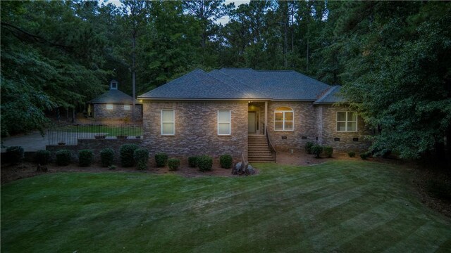 back of house with a lawn