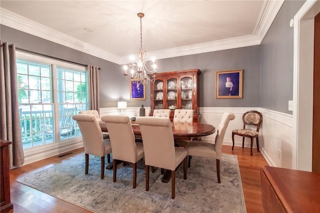 1849 Stoneridge Dr, Auburn, AL 36830 - dining room with a chandelier, wood finished floors, a wainscoted wall, and crown molding