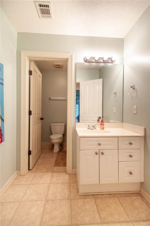 1849 Stoneridge Dr, Auburn, AL 36830 - bathroom with toilet, baseboards, vanity, and tile patterned floors