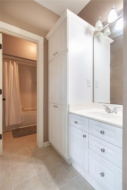 1849 Stoneridge Dr, Auburn, AL 36830 - full bathroom featuring vanity, tile patterned flooring, and shower / bath combo with shower curtain