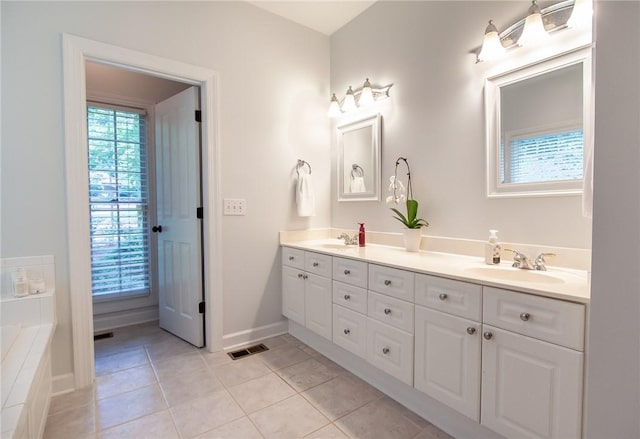 1849 Stoneridge Dr, Auburn, AL 36830 - full bathroom featuring double vanity, tile patterned floors, baseboards, and a bathtub