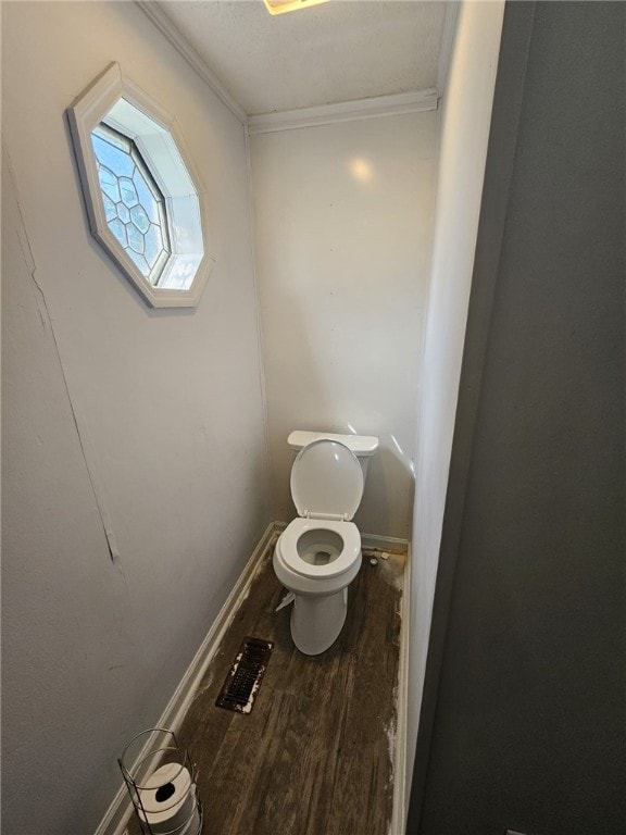 6507 22nd Ave, Valley, AL 36854 - bathroom with wood finished floors, toilet, ornamental molding, and baseboards