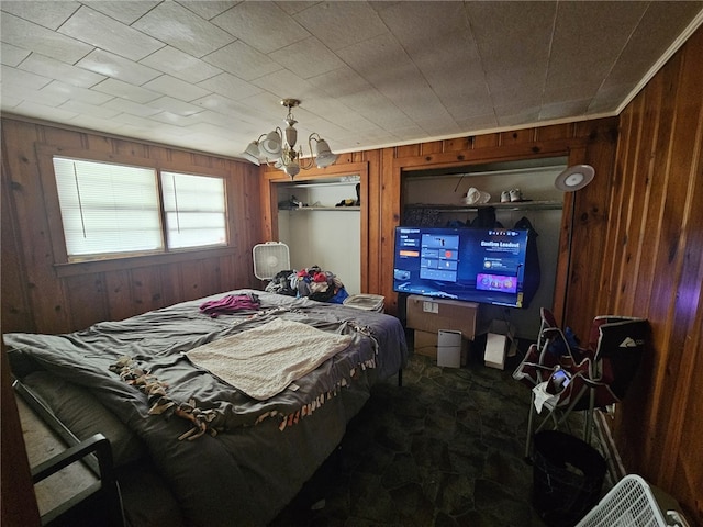 6507 22nd Ave, Valley, AL 36854 - bedroom featuring wood walls, a chandelier, and stone finish floors