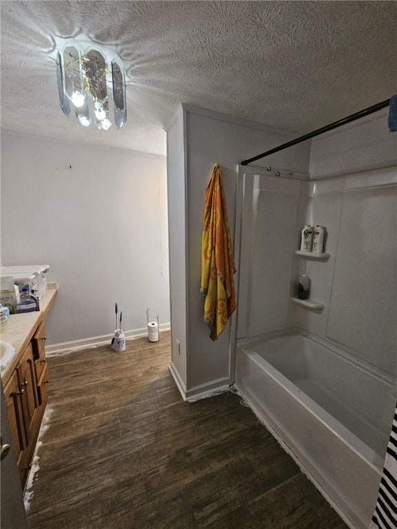 6507 22nd Ave, Valley, AL 36854 - bathroom featuring wood finished floors, vanity, shower / tub combination, baseboards, and a textured ceiling