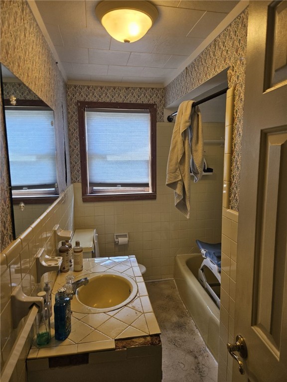 6507 22nd Ave, Valley, AL 36854 - bathroom with vanity, tile walls, shower / washtub combination, and toilet