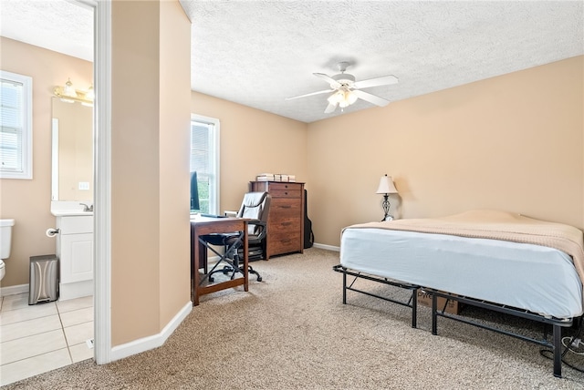 1477 N Donahue Dr Unit 2701, Auburn, AL 36832 - carpeted bedroom with a textured ceiling, a desk, connected bathroom, and ceiling fan