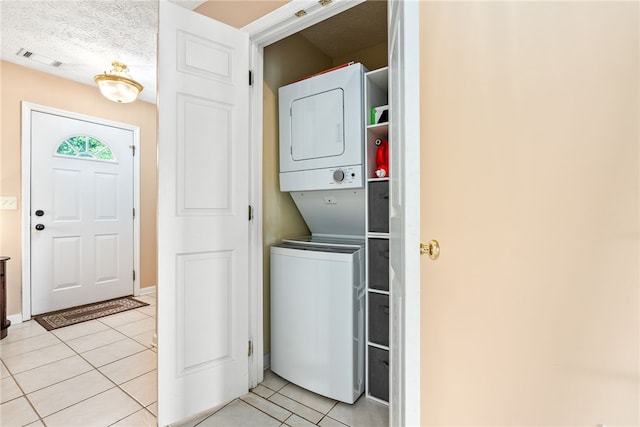 1477 N Donahue Dr Unit 2701, Auburn, AL 36832 - laundry room featuring stacked washing machine and dryer and light tile patterned flooring