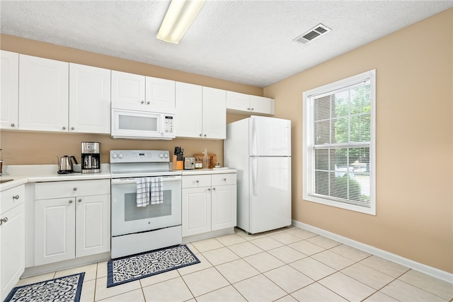 1477 N Donahue Dr Unit 2701, Auburn, AL 36832 - kitchen with white appliances, light countertops, white cabinetry, and a textured ceiling