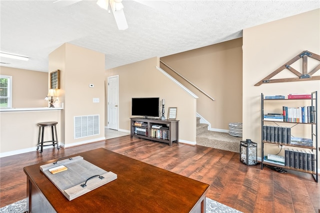 1477 N Donahue Dr Unit 2701, Auburn, AL 36832 - living area featuring wood finished floors, ceiling fan, stairs, and a textured ceiling