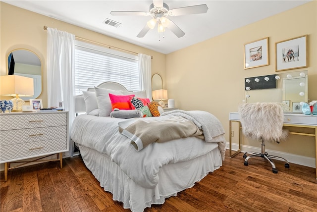 bedroom featuring visible vents, a ceiling fan, baseboards, and wood finished floors