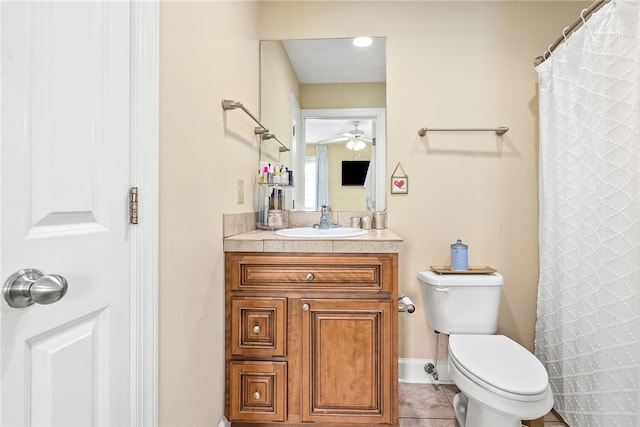 full bath featuring ceiling fan, tile patterned flooring, baseboards, vanity, and toilet