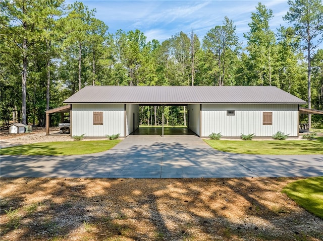 modern farmhouse featuring a carport and a front yard