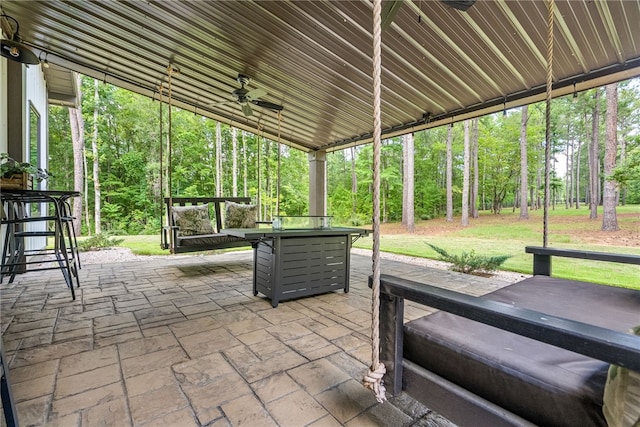 view of patio / terrace with ceiling fan and an outdoor fire pit