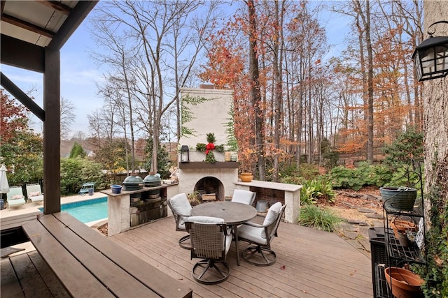 wooden deck with an outdoor fireplace