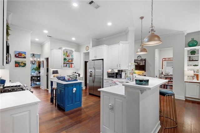 kitchen with white cabinetry, hanging light fixtures, stainless steel fridge with ice dispenser, blue cabinets, and a breakfast bar