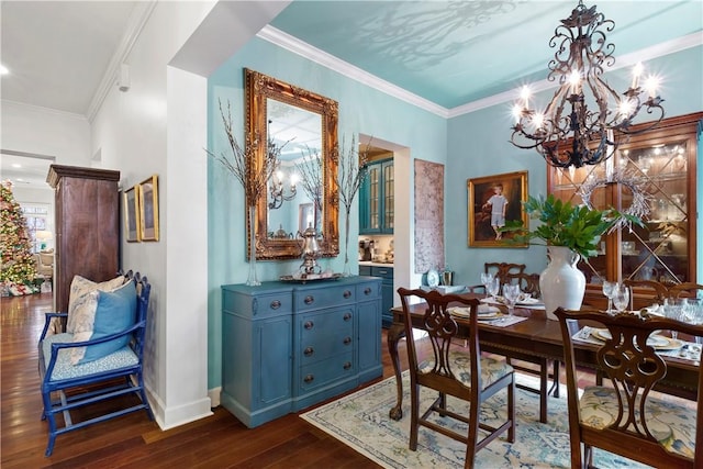 dining space with dark hardwood / wood-style flooring, crown molding, and a notable chandelier