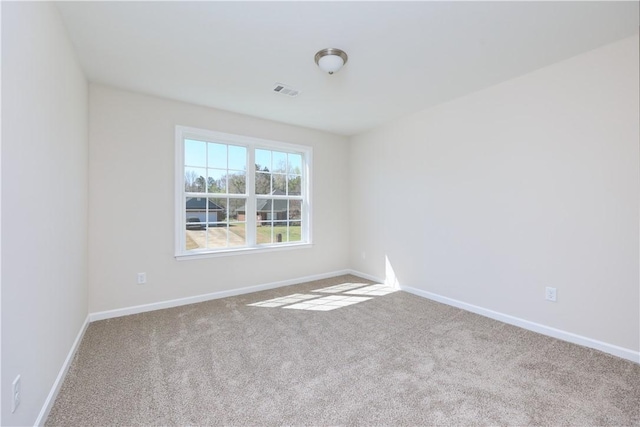 unfurnished room with baseboards and carpet floors