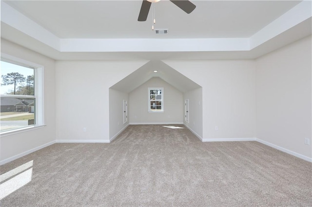 additional living space featuring ceiling fan, carpet, visible vents, baseboards, and plenty of natural light