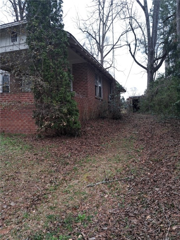 view of side of property featuring brick siding