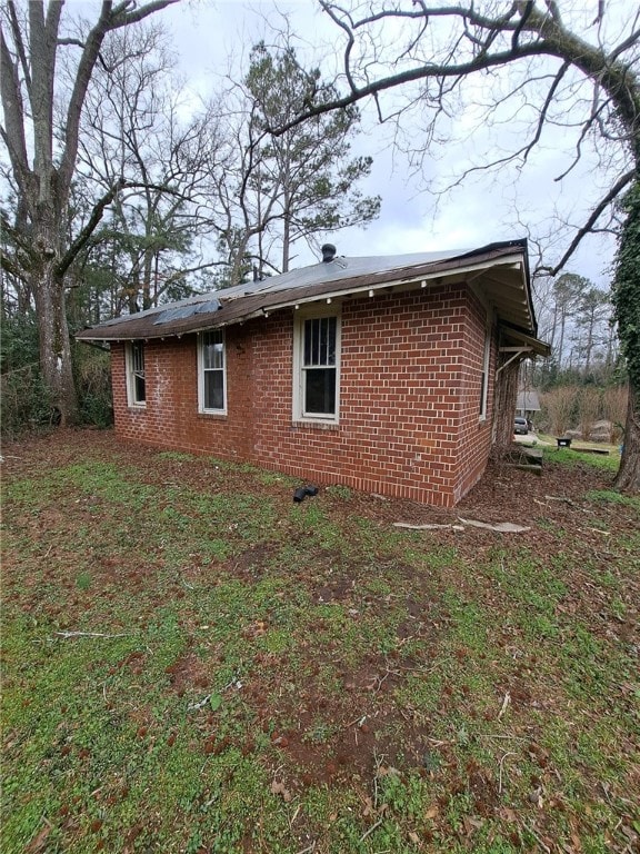 view of home's exterior with brick siding