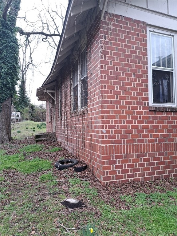 view of property exterior featuring brick siding