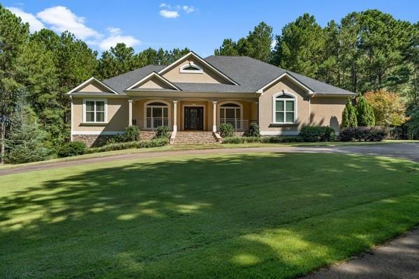 view of front of house featuring a front lawn and covered porch