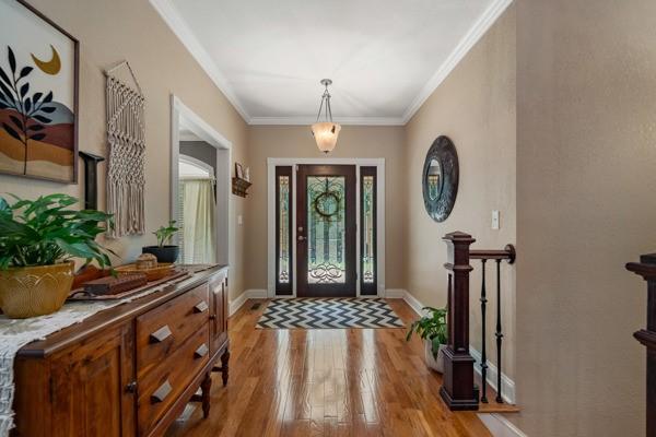 foyer with light hardwood / wood-style floors and ornamental molding