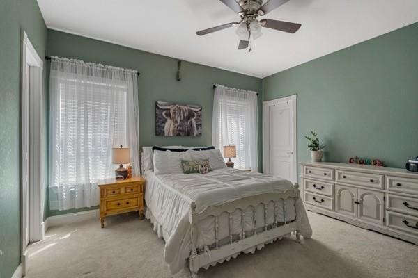 carpeted bedroom with ceiling fan