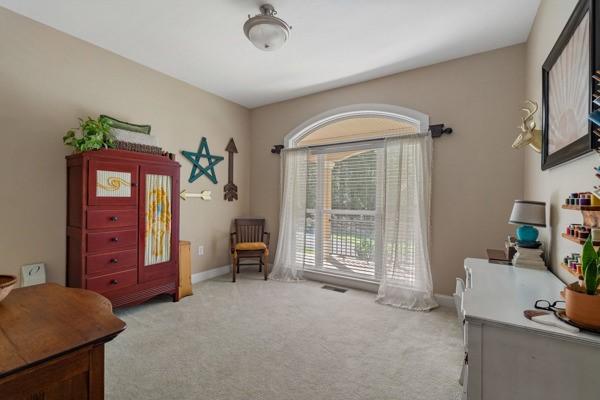 living area featuring light carpet