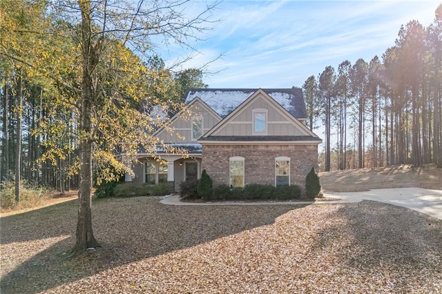 view of front of house with board and batten siding and brick siding