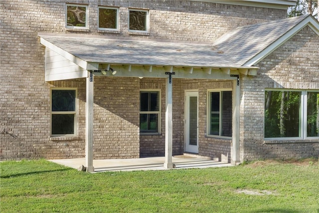 2133 W Farmville Rd W, Auburn, AL 36879 - property entrance with a shingled roof, a yard, and brick siding