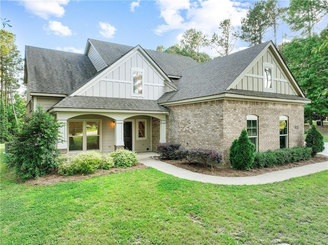 2133 W Farmville Rd W, Auburn, AL 36879 - view of front of property featuring board and batten siding, a front yard, a shingled roof, and brick siding