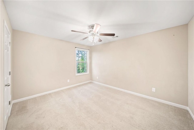 2133 W Farmville Rd W, Auburn, AL 36879 - spare room featuring baseboards, a ceiling fan, and light carpet