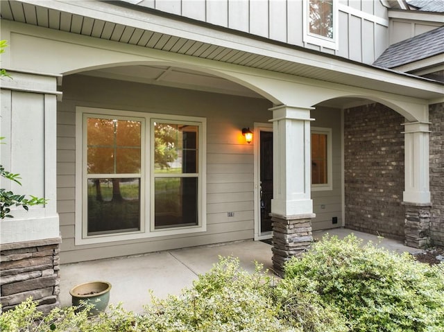 2133 W Farmville Rd W, Auburn, AL 36879 - doorway to property featuring brick siding, board and batten siding, and covered porch