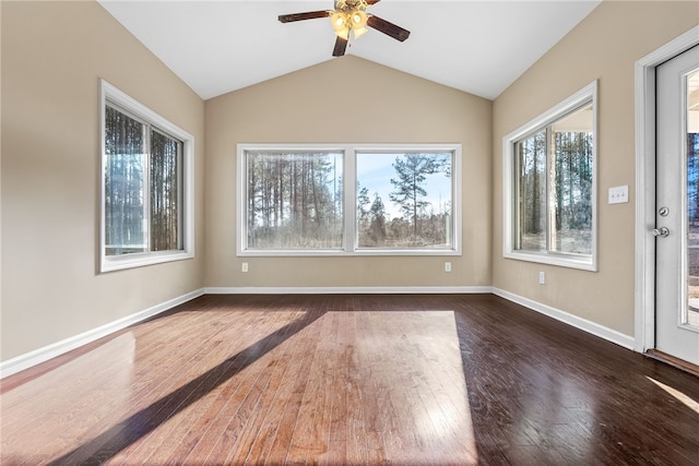 empty room with vaulted ceiling, ceiling fan, dark wood-style flooring, and baseboards