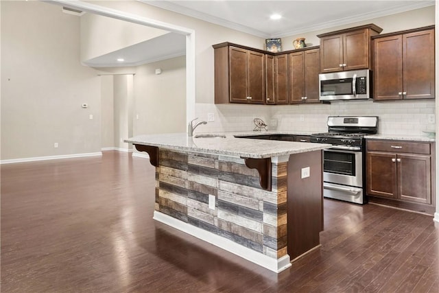 2133 W Farmville Rd W, Auburn, AL 36879 - kitchen with appliances with stainless steel finishes, a kitchen bar, a sink, a peninsula, and tasteful backsplash