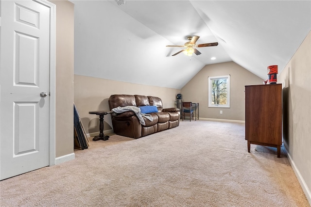 interior space featuring lofted ceiling, light colored carpet, ceiling fan, and baseboards