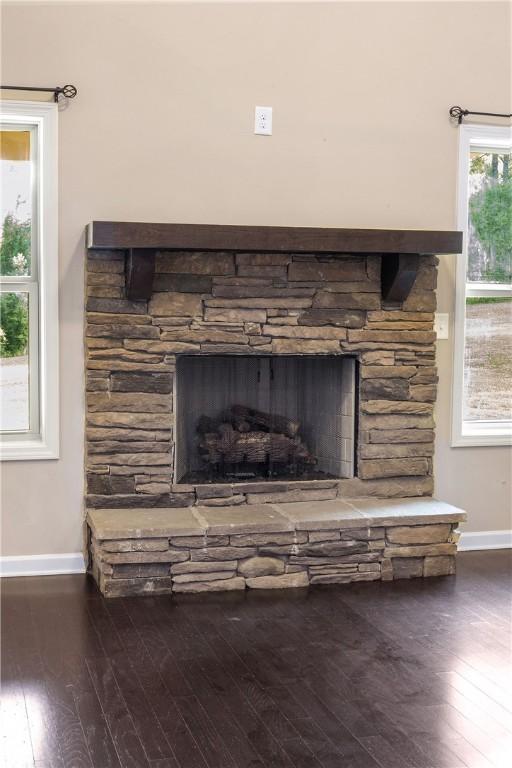 2133 W Farmville Rd W, Auburn, AL 36879 - detailed view of baseboards, wood finished floors, and a fireplace